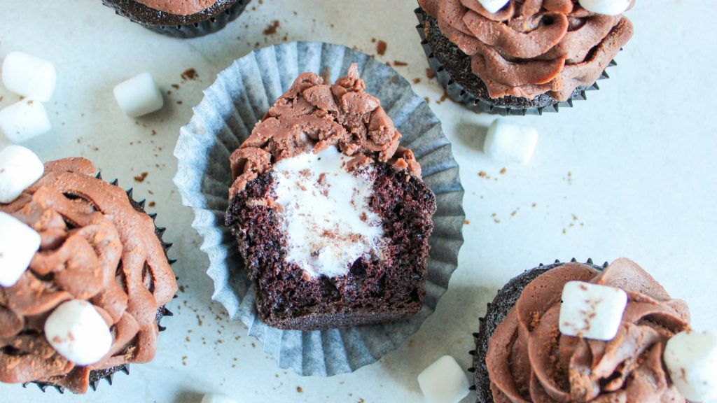a cupcake cut in half so you can see the marshmallow fluff in the middle