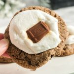 a hand holding up the smores cookie to show the top