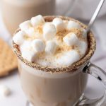 side view of a clear glass mug topped with marhsmallows and foam