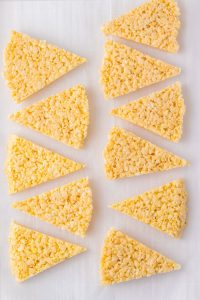 rice krispie treats on parchment paper cut into triangles